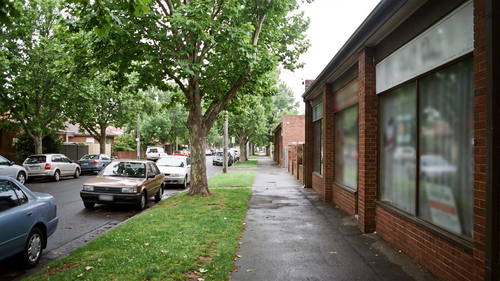 Tree-lined village permit-parking district with quiet kerbside vehicles