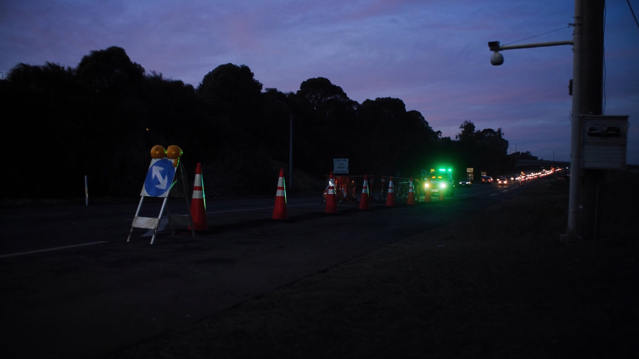 Australian temporary roadworks zone showing traffic controls and field conditions for review