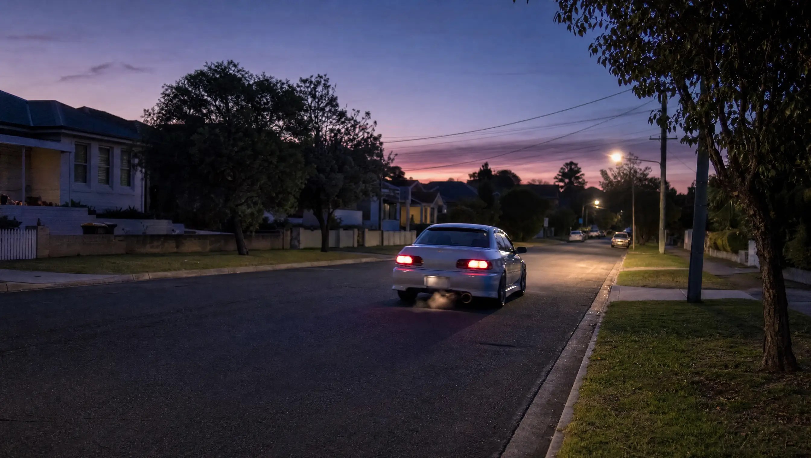 Vehicle associated with a noise complaint on a quiet residential street at dusk with no readable plate